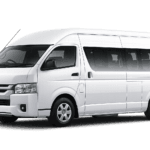 Toyota Hiace Commuter putih tampak serong depan dan samping untuk layanan sewa Hiace Jakarta dengan driver profesional