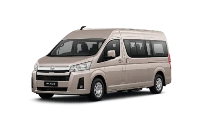 Toyota Hiace Premio coklat muda metallic tampak serong depan dan samping untuk layanan sewa Hiace Jakarta dengan driver profesional